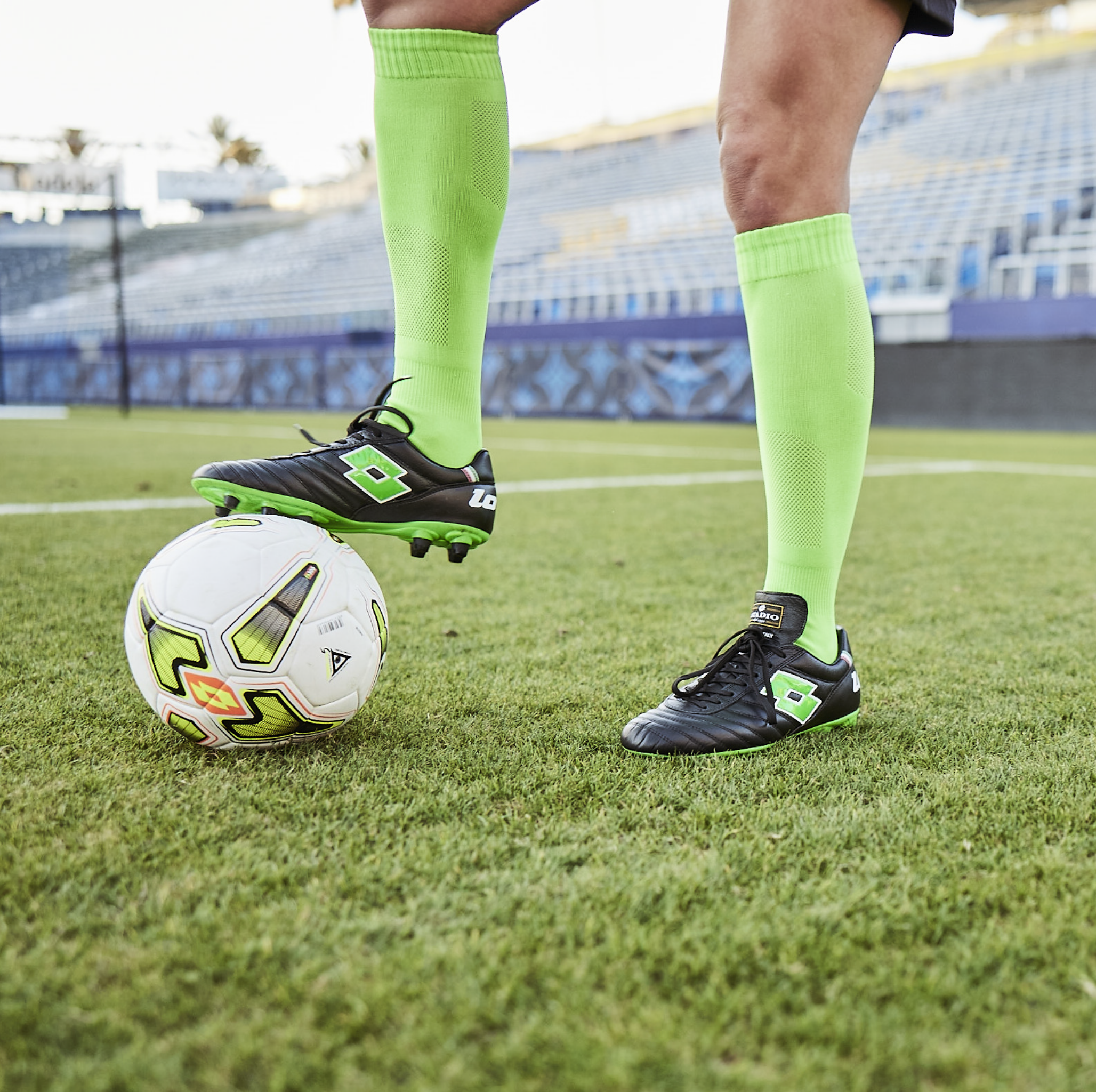 sofia huerta wearing lotto cleats, with a lotto soccer ball 